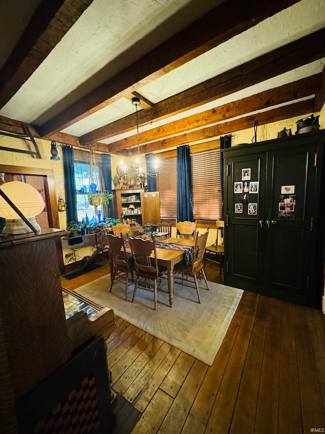 dining space featuring beamed ceiling and hardwood / wood-style flooring