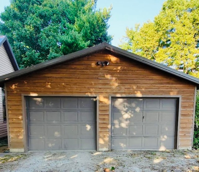 garage featuring wooden walls