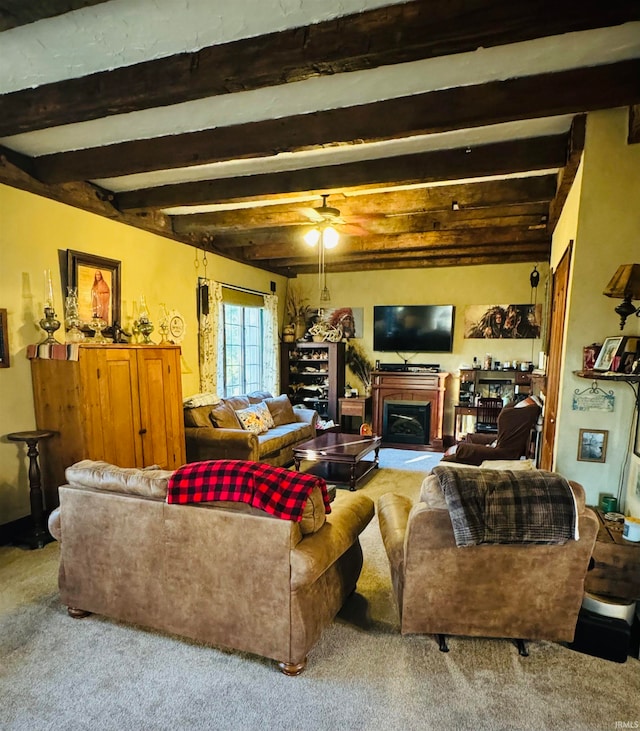 living room featuring carpet floors, beam ceiling, and ceiling fan