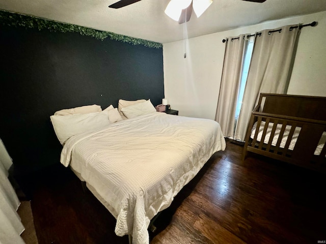 bedroom with ceiling fan and dark wood-type flooring