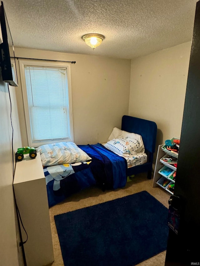 carpeted bedroom with a textured ceiling