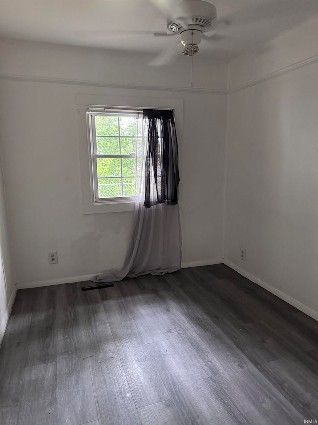 unfurnished room featuring ceiling fan and dark hardwood / wood-style flooring