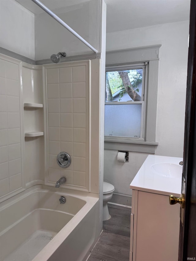 full bathroom featuring shower / washtub combination, hardwood / wood-style floors, vanity, and toilet