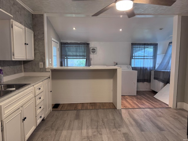 kitchen with ceiling fan, light hardwood / wood-style floors, kitchen peninsula, and white cabinetry