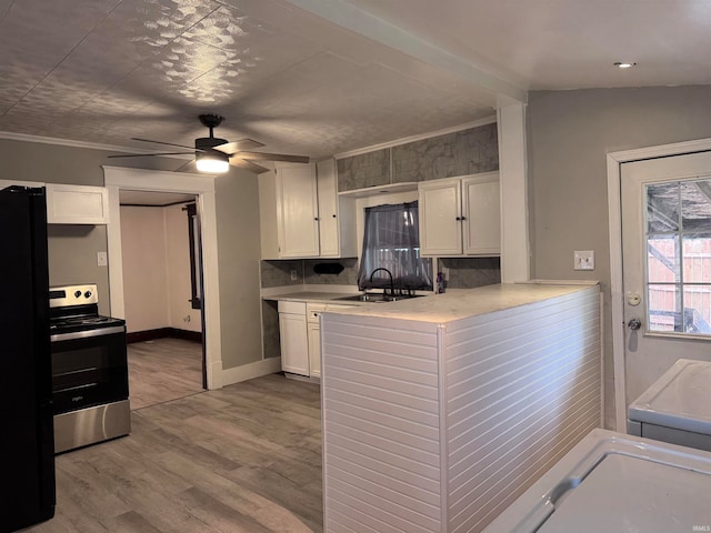 kitchen with ceiling fan, black fridge, wood-type flooring, white cabinetry, and stainless steel electric range oven