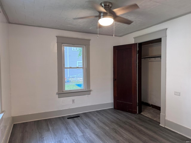 unfurnished bedroom featuring a closet, ceiling fan, and dark hardwood / wood-style floors