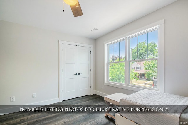 bedroom with ceiling fan, dark hardwood / wood-style flooring, and multiple windows