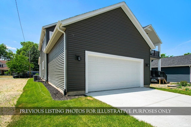 view of property exterior with a balcony, a yard, central AC unit, and a garage