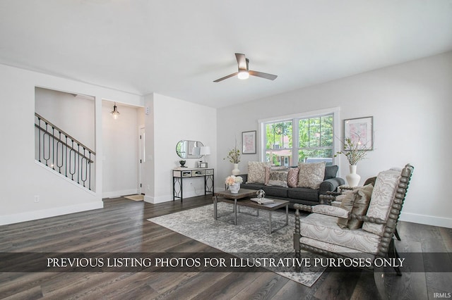 living room featuring dark wood-type flooring and ceiling fan