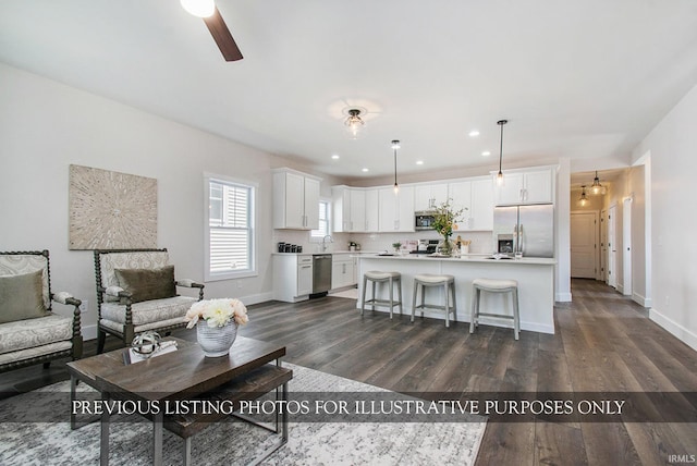 living room featuring dark hardwood / wood-style floors and ceiling fan