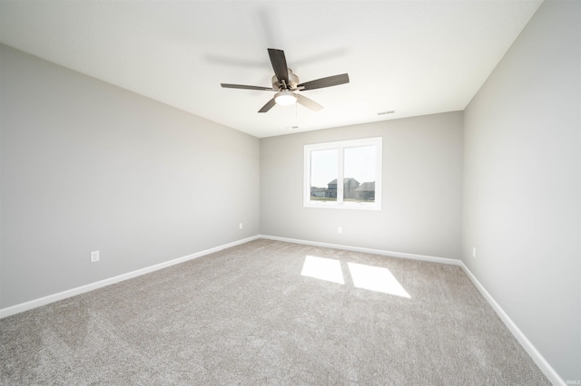 carpeted empty room featuring ceiling fan