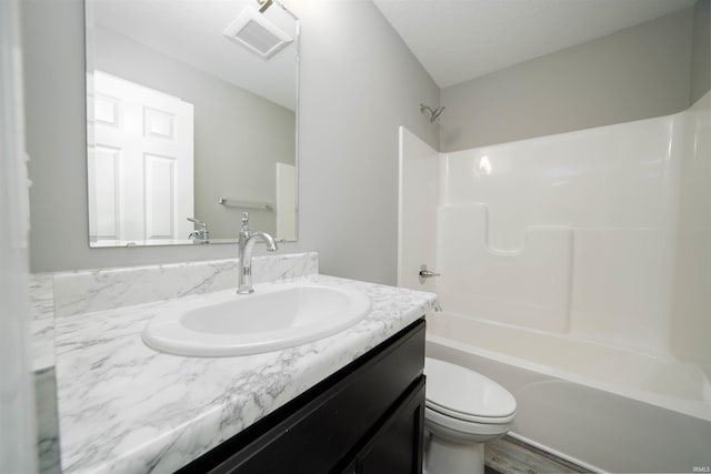 full bathroom featuring vanity, a textured ceiling, toilet, shower / bathing tub combination, and hardwood / wood-style floors