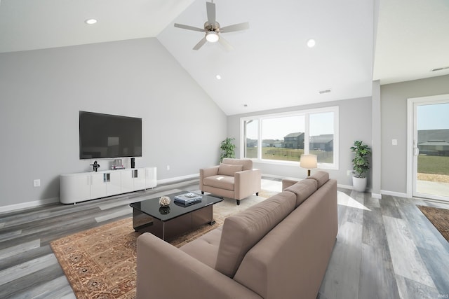 living room with ceiling fan, hardwood / wood-style floors, and high vaulted ceiling