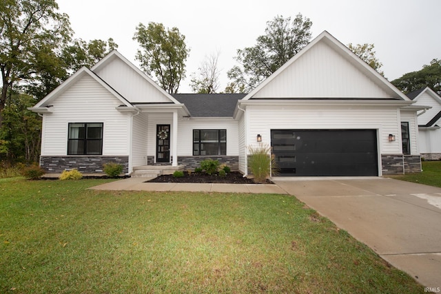 view of front of property with a garage and a front lawn