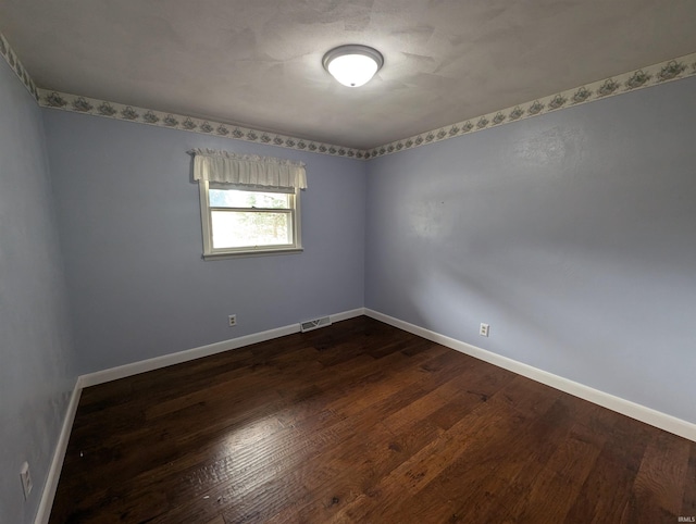 spare room with dark hardwood / wood-style floors