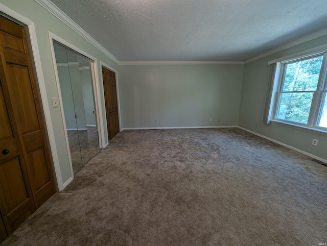 unfurnished bedroom featuring carpet floors, a textured ceiling, and crown molding