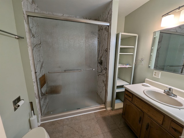 bathroom featuring vanity, tile patterned flooring, toilet, and a shower with door