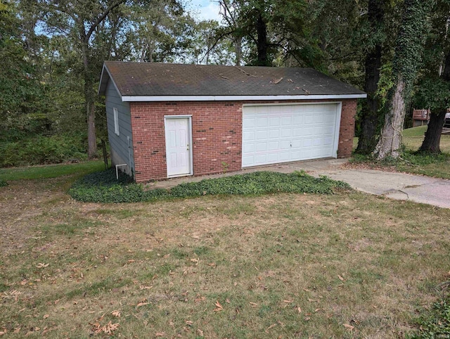 garage featuring a lawn