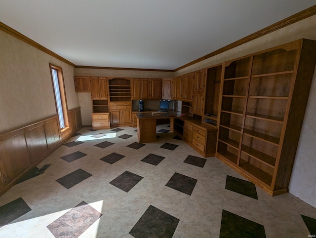 kitchen featuring built in desk, crown molding, and a center island