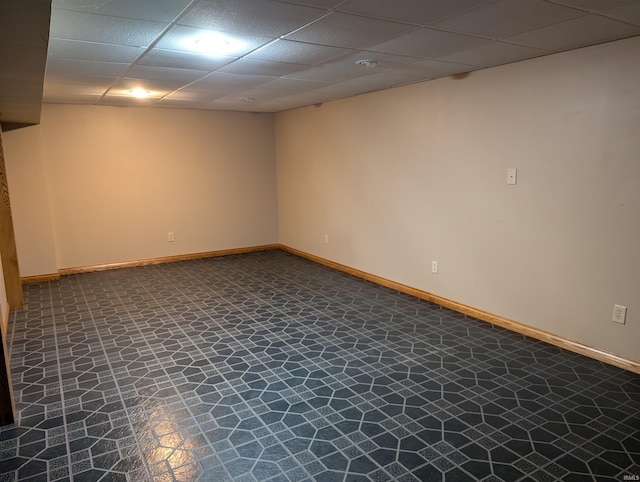 basement with a paneled ceiling