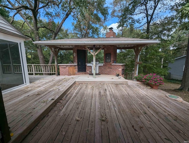 wooden terrace featuring a gazebo