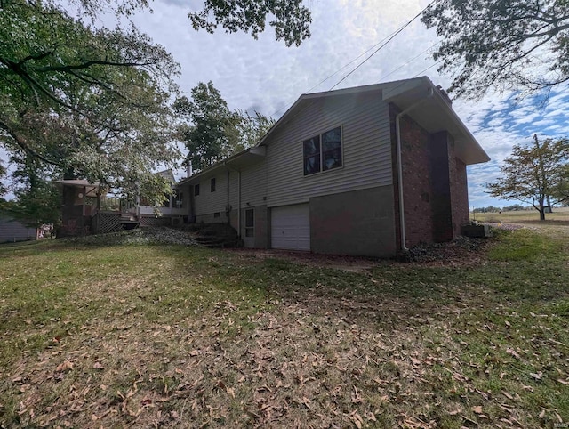 view of property exterior featuring a garage and a lawn