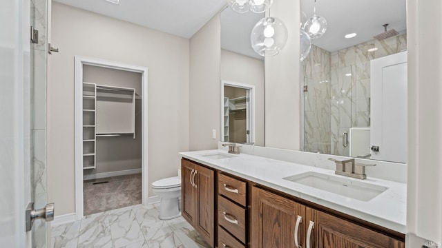 bathroom featuring walk in shower, vanity, and toilet