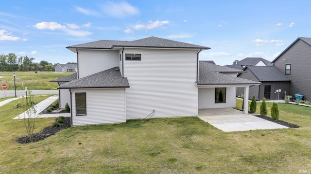 rear view of house with a yard and a patio area