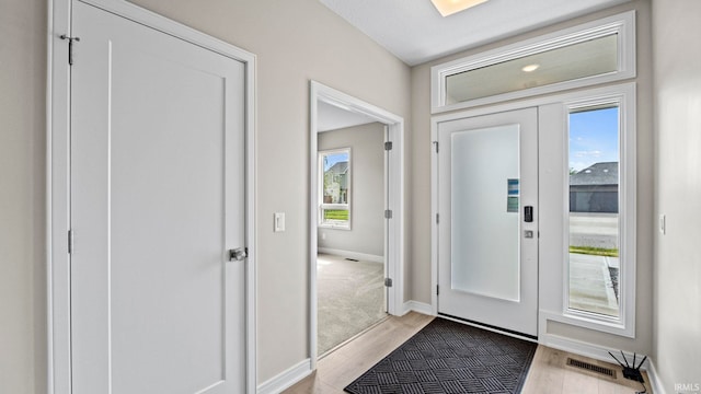 entrance foyer with light hardwood / wood-style flooring and french doors