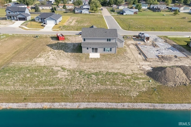 drone / aerial view featuring a water view and a residential view