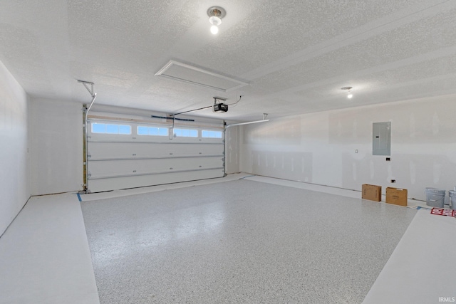 garage with a garage door opener and electric panel