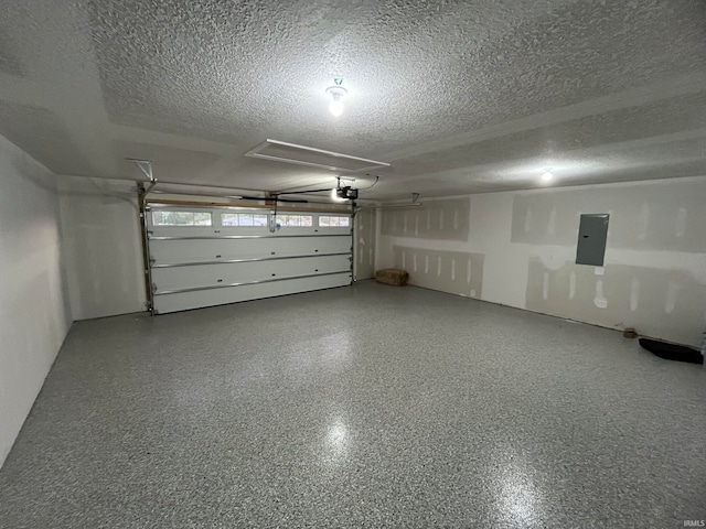 garage featuring electric panel and a garage door opener