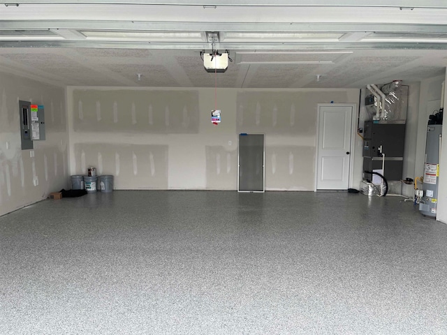 garage featuring electric panel, heating unit, gas water heater, and a garage door opener