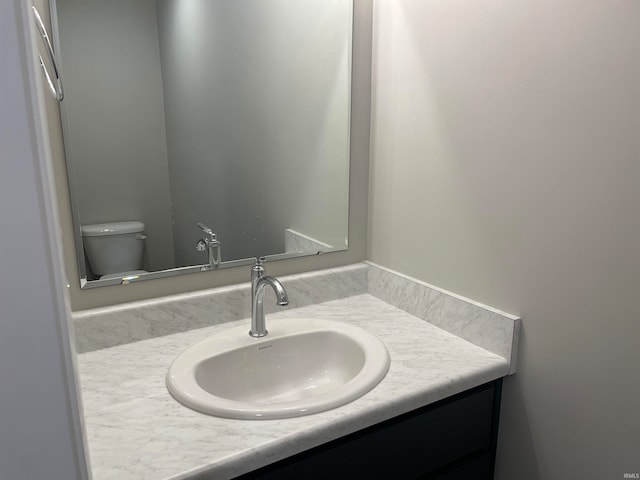 bathroom with toilet and vanity