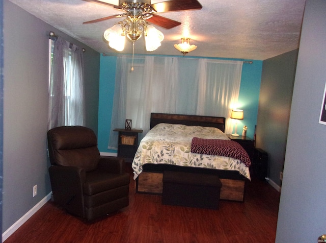 bedroom featuring ceiling fan, a textured ceiling, and dark hardwood / wood-style floors