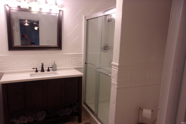 bathroom with vanity, tile walls, tasteful backsplash, and an enclosed shower