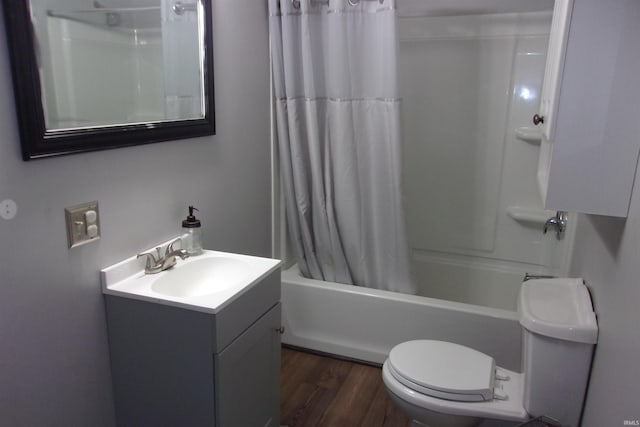 full bathroom with shower / tub combo, hardwood / wood-style flooring, vanity, and toilet