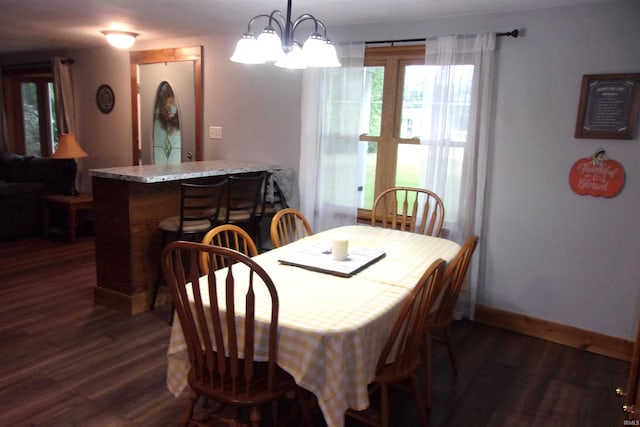 dining area featuring a chandelier and dark hardwood / wood-style flooring