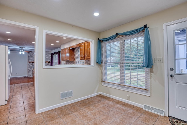 interior space featuring light tile patterned flooring and ceiling fan