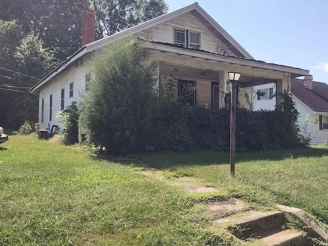 view of side of home featuring a yard