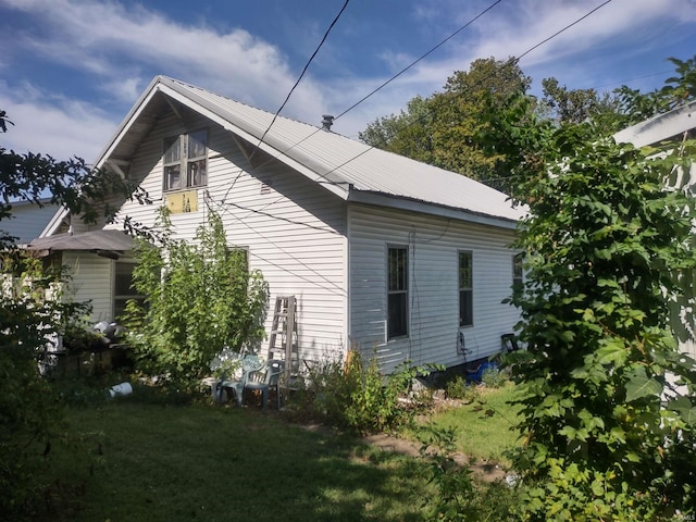 view of property exterior with a lawn