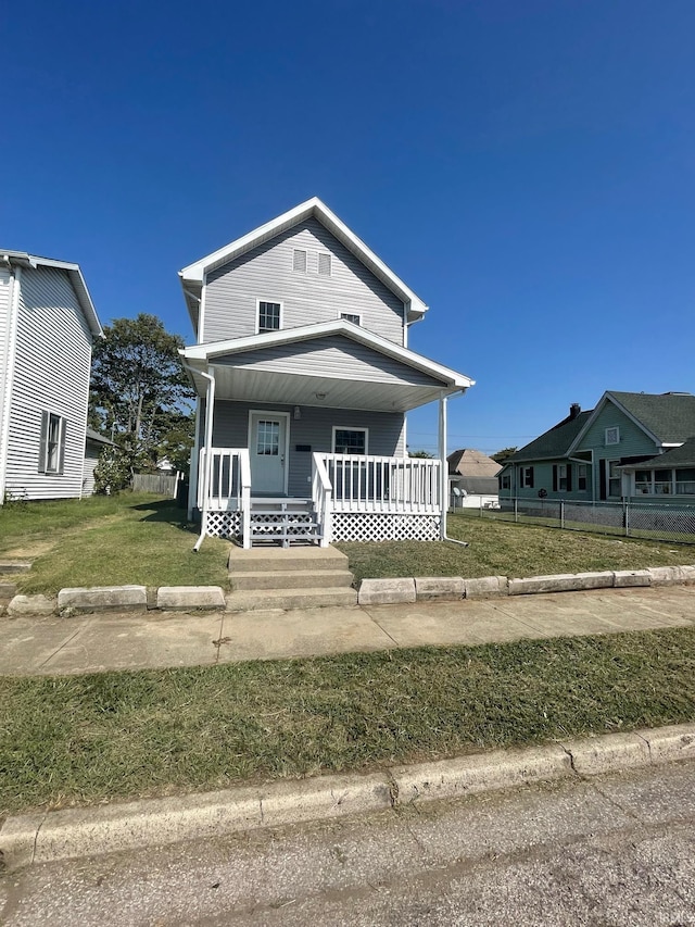 view of front of property featuring a front lawn and covered porch