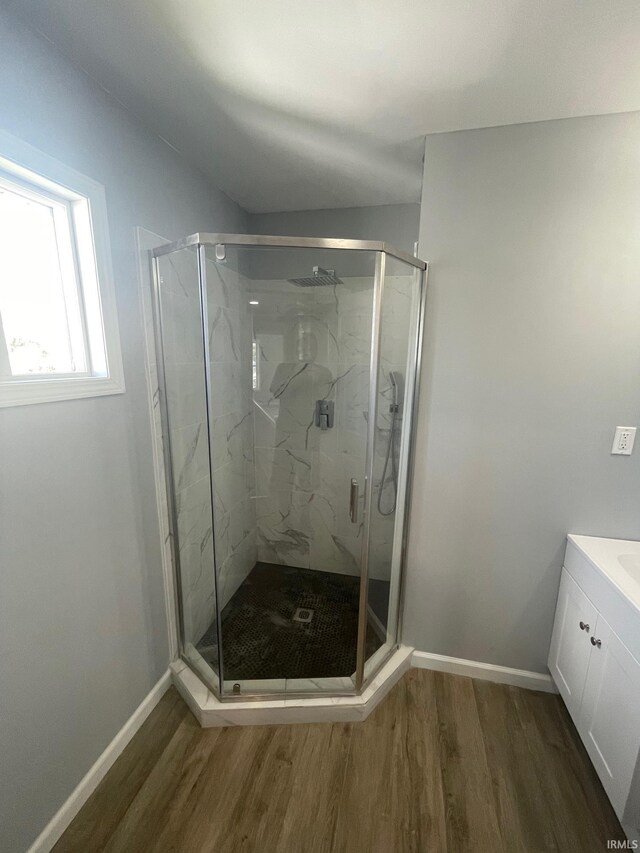 bathroom with vanity, an enclosed shower, and hardwood / wood-style flooring