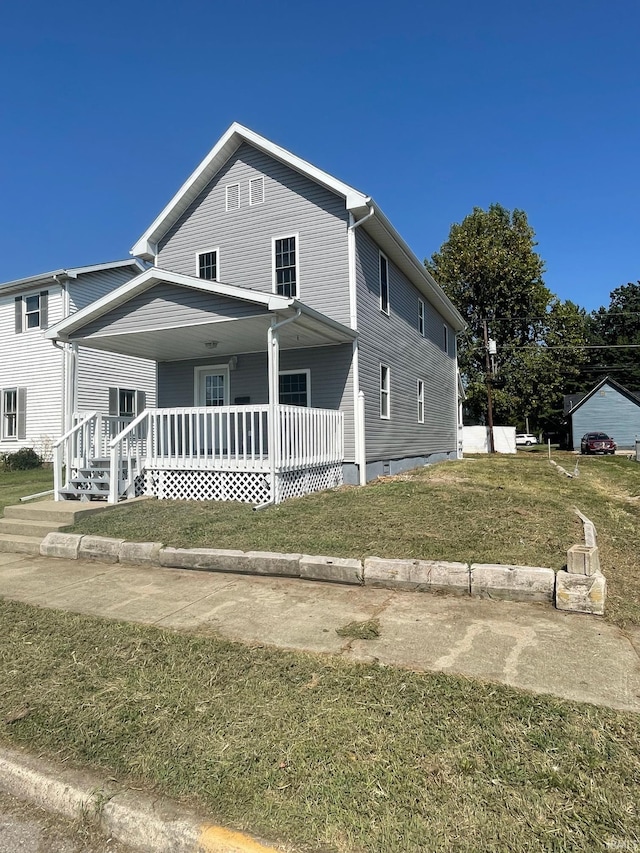 view of front facade featuring a front lawn and a porch