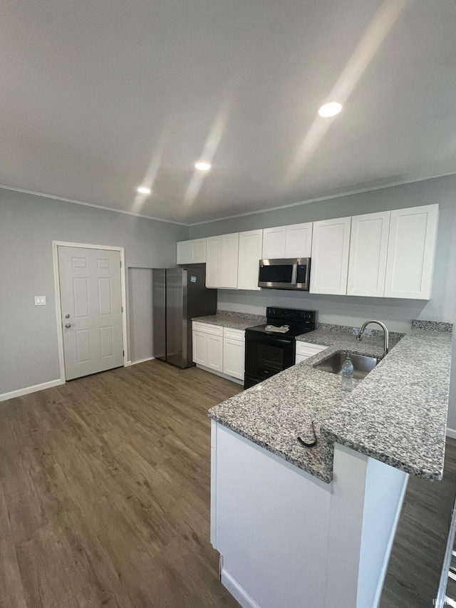 kitchen featuring dark wood-type flooring, white cabinets, kitchen peninsula, black range with electric cooktop, and sink