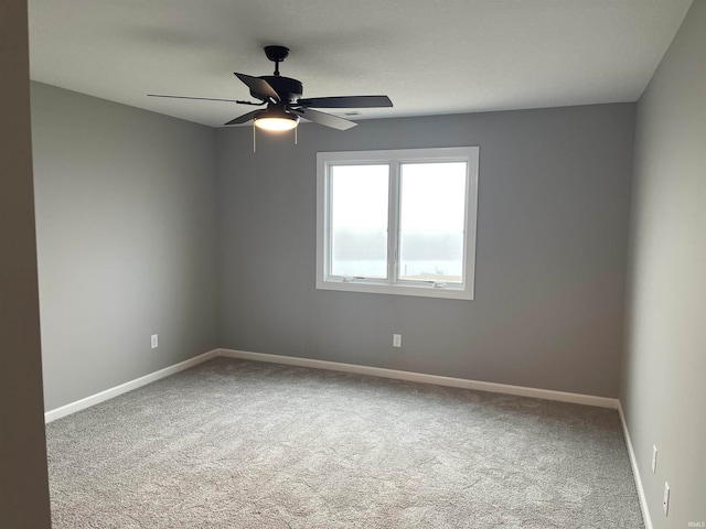 empty room with carpet floors and ceiling fan