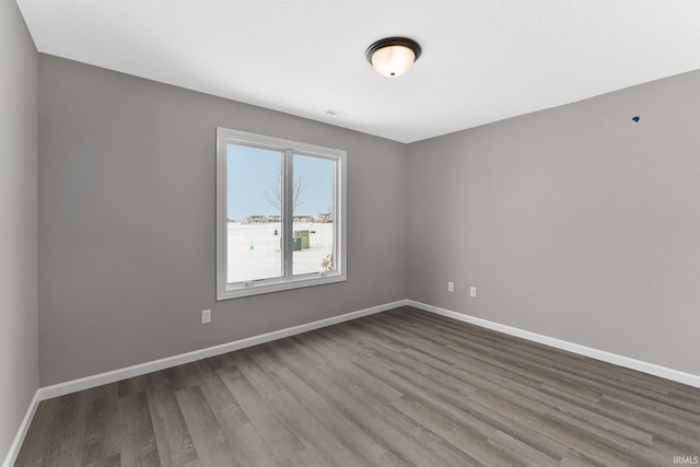 unfurnished room with hardwood / wood-style floors