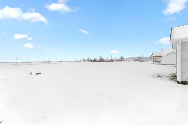 view of yard layered in snow