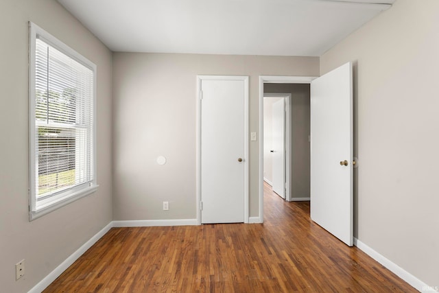 empty room featuring dark wood-type flooring