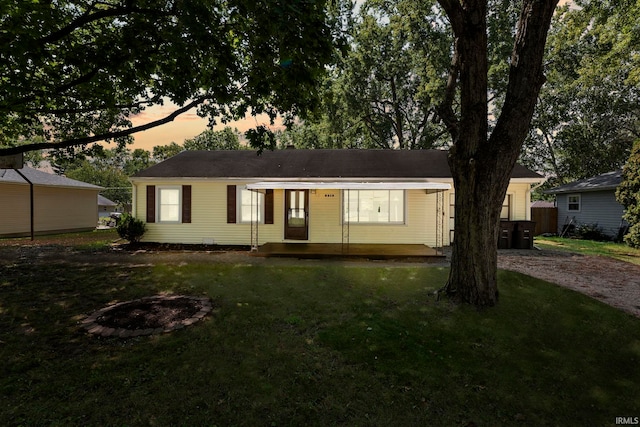 ranch-style home featuring a lawn